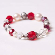 The Kate July Birthstone bracelet is a delicate and beautiful stretch bracelet in Swarovski crystal and finished with Balinese beads and sterling silver.  Each bracelet is unique and varies slightly.  This design incorporates shades of ruby red, clear crystal, cream, silver with Bali beads, stardust sparkle beads, and Swarovski pearls.  The actual piece can vary from the pictures shown due to the handmade nature and availability of materials.  Celebrate your favorite July birthday with a lovely easy to slip on stretch bracelet that is artfully and beautifully made.  Sparkles on your wrist and comfortable to wear.  Looks lovely stacked. Elegant Adjustable Crystal Stretch Bracelet, Elegant Crystal Stretch Bracelet For Gift, Elegant Hypoallergenic Crystal Bracelets, Silver Crystal Stretch Bracelet With Round Beads, Silver Stretch Bracelet With Crystal Round Beads, Elegant Crystal Bracelets With Gemstone Beads, Crystal Gemstone Beaded Bracelet Gift, Crystal Gemstone Beaded Bracelets As Gift, Silver Crystal Stretch Bracelet