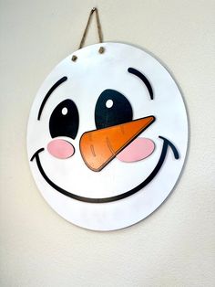 a snowman face hanging on the wall