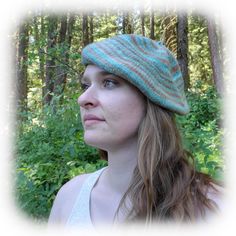 a woman wearing a knitted hat in the woods