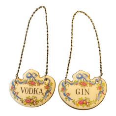 two wooden signs with chains hanging from the sides, one saying vodka and the other says gin