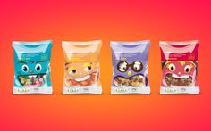 three bags of cereal with an owl face on the front and two are filled with nuts