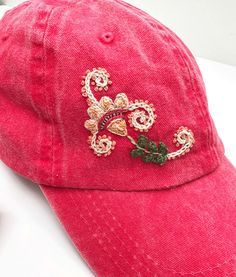 "100% cotton one size fits most embroidered hat with adjustable back buckle. Makes a great gift or a fun accessory!  DESCRIPTION: Vintage watermelon red stonewashed hand embroidered hat with colorful cotton embroidery inspired by Peruvian florals and motifs.  These are not made by machine, rather by hand, so small imperfections may occur. Cotton twill, low profile, floppy style. The hat circumference section is 22.04\"-23.22\". Adjustable metal buckle in back. Recommended hand wash cold and hang Casual Red Embroidered Hat, Adjustable Multicolor Embroidered Baseball Cap, Floral Embroidered Adjustable Snapback Hat, Floral Embroidery Baseball Cap, One Size Fits Most, Pink Purple Party, Floral Embroidered Baseball Cap, One Size Fits Most, Vintage Watermelon, Burned Hats, Denim Baseball Cap