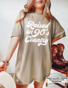 a woman wearing a t - shirt with the words raised at 90's country on it