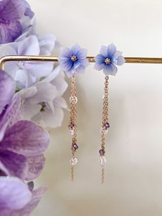 Experience the enchanting fusion of nature's beauty and elegant sophistication with these Shrink Plastic Purple Hydrangea Flower Stud Earrings adorned with Amethyst Crystal and Pearls Drops. Handmade with meticulous attention to detail, these earrings are a true embodiment of artistry and grace. Each earring showcases a meticulously designed purple hydrangea flower, crafted from shrink plastic to capture the intricate charm and shades of the blossoms. The purple hues evoke a sense of enchantment Elegant Lavender Flower Earrings For Gift, Purple Flower-shaped Whimsical Jewelry, Whimsical Purple Flower Jewelry, Elegant Purple Flower Earrings, Elegant Purple Flower Shaped Earrings, Whimsical Purple Flower-shaped Jewelry, Lavender Flower Earrings For Wedding, Delicate Purple Earrings For Wedding, Elegant Lavender Flower Shaped Jewelry