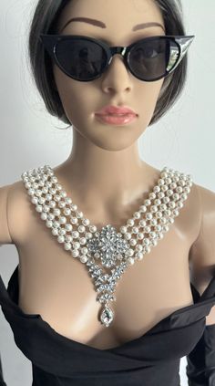 Introducing the newest addition to our statement jewellery collection, this stunning 5 strands pearl necklace. This necklace is made for a special occasion and it's ready to make a statement.  Materials: Luxurious 10mm Shell Pearls, 4mm crystal beads, Platinum plated brass brooch and clasp.  Brooch length - 5 inches/13cm Brooch width - 2 inches/6cm Each glossy bead is crafted to mimic the radiant beauty of real pearls, creating a sophisticated and versatile piece. They are luxurious, heavy and c Drop Pearl Necklace, Brass Brooch, Pearls Jewellery, Radiant Beauty, Pearl Drop Necklace, Oyster Shells, Back Drop, Statement Jewellery, Real Pearls