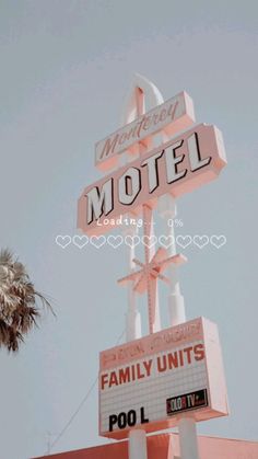 the neon motel sign is pink and white