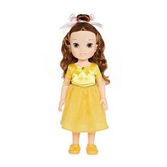 the doll is wearing a yellow dress with a white bow on it's head