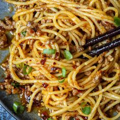 noodles with meat and vegetables in a pan, ready to be eaten by the chef