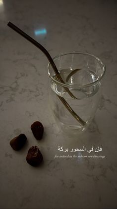 a glass filled with water and some chocolates