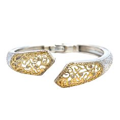 A Sterling Silver and 18 Karat Yellow Gold Hinged Bangle Bracelet Featuring Swirled Design Accented by 112 Round Diamonds of I1 Clarity and Light Brown Color Totaling Approximately 0.56 Carats. Finished Weight is 30.0 Grams. Luxury Formal Cuff Bracelet With Intricate Design, Luxury Intricate Design Cuff Bracelet For Formal Occasions, Luxury Intricate Design Formal Cuff Bracelet, Formal Diamond Bangle Bracelet With Oyster Detail, Luxury Adjustable Cuff Bracelet With Intricate Design, Elegant Cuff Bracelet With Intricate Design For Formal Events, Elegant Cuff Bracelet With Intricate Design For Formal Occasions, Luxury Filigree Round Bracelets, Formal White Gold Bangle With Intricate Design