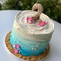 a blue and white cake sitting on top of a table