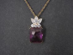 This beautiful estate pendant is gold vermeil over sterling silver. It features a 12x15mm synthetic purple sapphire accented by cubic zirconias. Measurements: 1/2 by 1 inch Marks: HC, 925 Comes on an 18 inch 14K Gold Filled chain. Condition: Excellent Gold Necklaces With Accent Stones For Formal Occasions, Gold Formal Necklace With Center Stone, Formal Gold Necklace With Center Stone, Sapphire Pendant Necklace, Sapphire Necklace Pendants, Purple Sapphire, Sapphire Pendant, Gold Filled Chain, Gold Vermeil