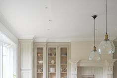 a large kitchen with white cabinets and marble counter tops, along with an island in the middle