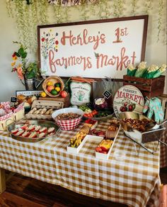 a table topped with lots of food next to a sign that says hedley's 1st farmer's market