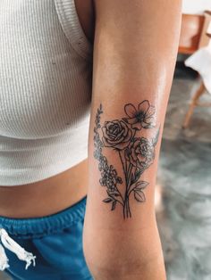 a woman with a flower tattoo on her arm