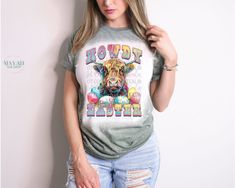 Howdy Easter Bleached Tee Introducing our Howdy Easter Bleached Tee, a must-have for Easter enthusiasts who adore cows! Crafted for comfort, this tee boasts a soft, lightweight feel with a unisex fit, available in sizes Small through 2X. Choose from a variety of vibrant shirt colors to suit your style. Soft style feel for luxurious comfort Light and breathable for all-day wearability Unisex fit ensures versatility for everyone Sizes ranging from Small to 2X accommodate diverse body types A spect Casual Short Sleeve Cow Print Tops, Casual Cow Print Tops With Relaxed Fit, Spring Cow Print Short Sleeve Top, Spring Cow Print Cotton Top, Spring Cotton Cow Print Top, Casual Cow Print Tops For Spring, Casual Spring Tops With Cow Print, Spring Casual Cow Print Tops, Casual Cow Print T-shirt For Fall