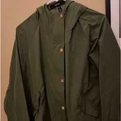 Windbreaker Jacket For Women Olive Green Button Snaps, Side, Pockets Tying Cord, At Bottom Of Jacket Has A Hood Nwt Casual Fall Raincoat With Button Closure, Casual Raincoat With Button Closure, Casual Button-up Outerwear By Forever 21, Forever 21 Casual Button-up Outerwear, Forever 21 Jacket, Jacket For Women, Green Button, Utility Jacket, Windbreaker Jacket