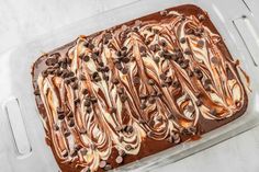 a pan filled with chocolate and marshmallows on top of a white counter