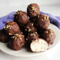 a white plate topped with chocolate covered truffles