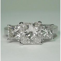 three stone diamond ring on white background