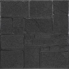 a black brick wall with several square tiles