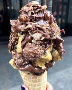 an ice cream cone filled with chocolate covered cookies