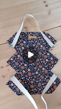 the bag is made out of fabric and has straps on each side that are attached to it