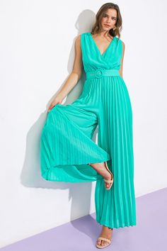 This stylish jumpsuit is the perfect addition for any spring wardrobe. It is made from a solid woven fabric and features a surplice neckline, sleeveless construction, and pleated pants for a flattering silhouette. An elasticized waist and self-tie belt provide a comfortable, adjustable fit. The surplice back adds a touch of elegance to your look. Details Self: 100% Polyester Lining: 100% Polyester Size & Fit - Model is 5`8 " And Wearing Size Small - Measurements Taken From Size Small - Approx. Length: 60” Stylish Jumpsuit, Kimono Sweater, Luck Charm, Surplice Neckline, Luck Charms, Pleated Pants, Spring Wardrobe, Sweater Coats, Tie Belt