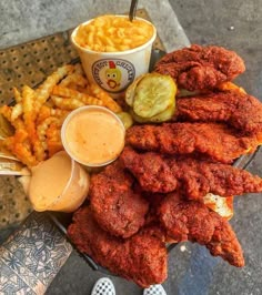 fried chicken and french fries with dipping sauce on the side