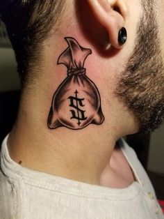 a man with a tattoo on his neck has a bag of money behind his ear