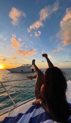 two people toasting while on a boat in the ocean