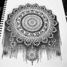 a black and white drawing of an intricate design on a piece of paper with ink