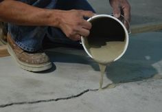 a man is pouring cement into a bucket