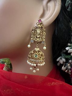 Matte Antique Gold Finish Jhumuka Earrings /Goddess Lakshmi Ruby Emerald /Beautiful  Earrings /Medium Heavy Temple Jewelry/Indian Jewelry These fabulous earrings are high-quality and will match with a number of outfits. Wear them for any occasion, or give them as a gift.  DETAILS: Includes Two Earrings only. Length: 3 .inches long  Weight for Earring Set: 1.65oz (47 g) Earring backs push on/off.  Material: Imitation Antique gold Finish , Pearls Drop Ruby Green Emerald Stones. Finish: Premium Antique gold finish.  NOTE: We try our best to show you photos of our items as they appear in real life, but please note that variations in color occur due to differences in lighting and screen settings.  PRODUCT CARE: - Avoid contact with heat/fire, water, and chemicals such as perfumes or any sprays Gold Earrings With Peacock Design For Puja, Gold Fusion Earrings With Peacock Design, Festive Spiritual Chandbali Earrings, Fusion Style Earrings For Puja And Festivals, Temple Jewelry Earrings With Peacock Design For Rituals, Temple Jewelry Earrings For Rituals, Festive Spiritual Gold Earrings, Spiritual Style Drop Earrings For Wedding, Spiritual Festive Earrings For Festivals