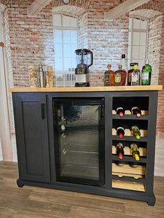 a wine rack with many bottles on top of it in front of a brick wall