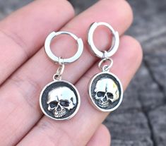 Skull Huggie Hoops details:-.925 solid sterling silver.-12mm huggie hoop approx. 1/2" diameter (latch back about 9mm through ear lobe), 2mm width/thickness.-Skull Measures 13mm round-Full dangle about 1.25"-Single or Pair availableConnect with us on Instagram @a_wild_violet for sales and giveaways!**All items are in stock and ship within 2-5 business days from received payment (excluding Saturday/Sunday) from the US. If you are within the US please expect 3-7 business days for shipping transit a Internally Threaded Dangle Hoop Earrings As Gift, Nickel-free Sterling Silver Huggie Earrings As Gift, Internally Threaded Hoop Earrings As A Gift, Gothic Small Hoop Silver Jewelry, Gothic Silver Small Hoop Jewelry, Internally Threaded Small Hoop Huggie Earrings For Gift, Small Hoop Internally Threaded Huggie Earrings For Gifts, Handmade Sterling Silver Huggie Cartilage Earrings, Silver Gothic Hoop Earrings As Gift