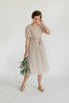 Update your sunny weather wardrobe with the Ramona Dress! Featuring a ditsy floral print in a lovely tan shade, this midi dress has a classic crew neckline and removable tie-belt at the waist that creates a flattering silhouette on all body types and is maternity friendly! Pair with anything from flats to sneakers or heels to match the occasion! Exclusively designed with you in mind. Self & Lining 100% Polyester Hand Wash Cold Do Not Bleach Hang to Dry Low Iron if Needed Fully Lined Maternity/Bu Sunny Weather, Low Iron, Ditsy Floral, Floral Midi Dress, Tie Belt, Body Types, Crew Neckline, Final Sale