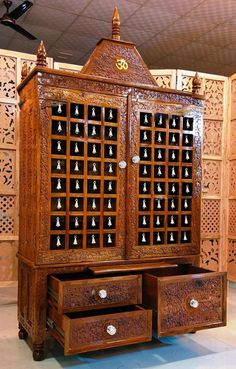 an ornate wooden cabinet with two drawers