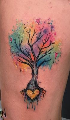 a colorful tree tattoo with hearts on the trunk and branches painted in watercolors