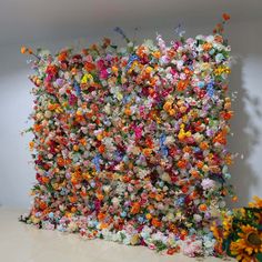 a wall made out of many different colored flowers