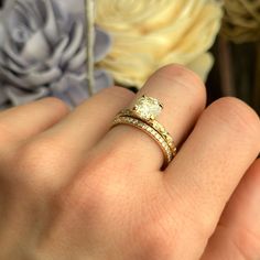 a close up of a person's hand with a wedding ring on their finger