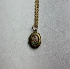 "This sweet, small, OVAL antique brass locket has a vintage Guilloche pale pink enamel cabochon with pink flowers set on the front, giving it the perfect cottage core feel.  It hangs on a 16\" gold stainless steel chain necklace.  The locket is approximately 11x16mm.  The enamel cabochon is 6x8mm.  Arrives in an eco-friendly jewelry box, ready for gifting. MORE lockets in my shop! FREE SHIPPING! THANK YOU FOR VISITING MY SHOP!" Vintage Gold Jewelry Aesthetic, Locket Necklace Aesthetic, Gothic Locket, Small Lockets, Ranching Life, Vintage Locket Necklace, Dress Reference, Locket Necklace Vintage, Dark Acadamia