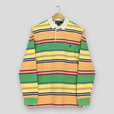 Vintage Polo Ralph Lauren Striped Rugby Shirt Large Polo Ralph Lauren Collared Shirt Ralph Lauren Multicolor Stripes Rugby Polo Shirt Size L Good Used Condition. Have minor stains, REFER PICTURE. Size (On Tag) : Size L **To make sure if it FITS YOU, refer at the exact measurements. Size Measurement (All measurements were taken lying flat) : Width [armpit to armpit] : 21 inches / 53 cm Length [shoulder to end of garment] : 28 inches / 71 cm THIS IS USED CLOTHING! PLEASE DON`T EXPECTED IT TO BE LI Rugby Polo, Vintage Polo Ralph Lauren, Vintage Polo, Rugby Shirt, Collared Shirt, Used Clothing, Collar Shirts, Vintage Tshirts, Rugby