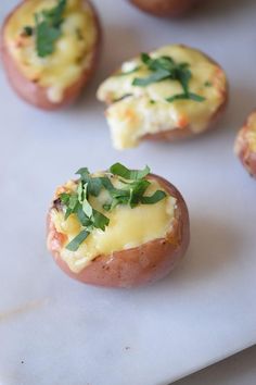 baked potatoes with cheese and herbs on top