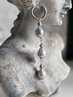 Make your mother sigh (but not actually) with these tear drop dangle earrings featuring baby grey keshi button pearls and grey pear shaped freshwater pearls. These earrings are one of a kind and handmade in Los Angeles. Features: Comes as a pair Length from end of hoop to end of earring is 1.5 inches .925 sterling silver wire and click back hoops Silver Teardrop Baroque Pearl Jewelry, Silver Teardrop Earrings With Pearl Charm, Teardrop Pearl Charm Earrings, Silver Long Drop Single Pearl Earring, Sterling Silver Teardrop Pearl Earrings With Charm, Teardrop Baroque Pearl Earrings With Pearl Charm, Gray Pearl Drop Jewelry For Gift, Teardrop Baroque Pearl Chain Earrings, Silver Tahitian Pearl Teardrop Jewelry