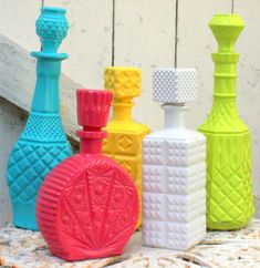 several different colored vases sitting next to each other