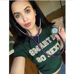 a woman with a stethoscope on her neck is taking a selfie