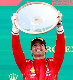 a man holding up a trophy in the air