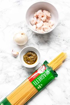 ingredients to make shrimp pasta laid out on a marble counter