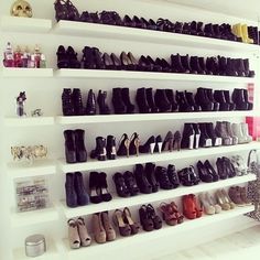 there are many pairs of shoes on the shelves